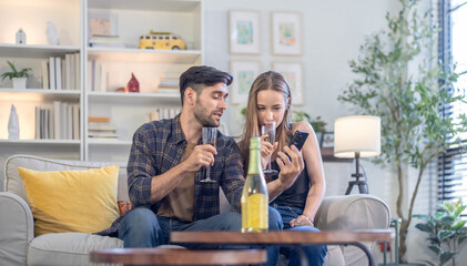 Diverse startup colleagues enjoy drinks, socializing in a relaxed, stylish living room post party.