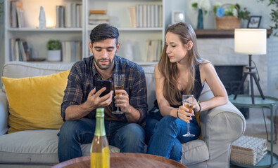 Diverse startup colleagues enjoy drinks, socializing in a relaxed, stylish living room post party.