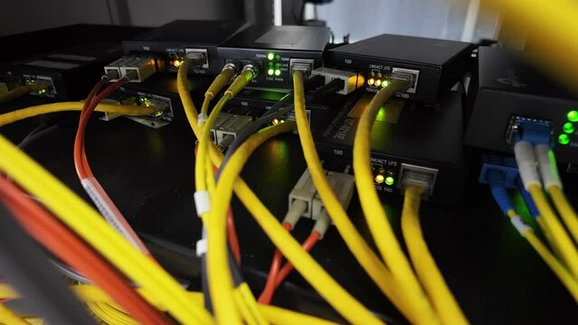 Fiber optic cables for connecting multi-mode and single-mode networks and communications systems with media converters and background lighting.