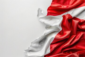 a red and white flag flutters in the wind against a white wall