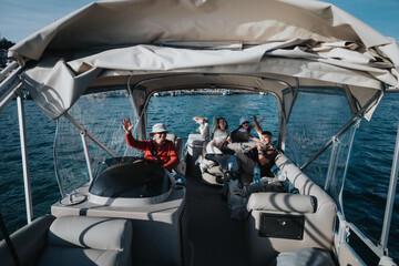 Group of cheerful friends on a boat waving and having fun during a leisurely day on the water.