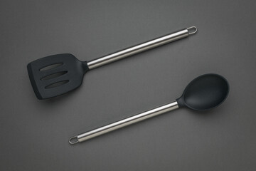 Modern Stainless Steel Kitchen Utensils on Dark Background