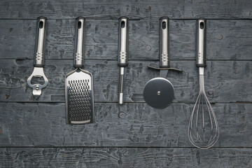 Stainless Steel Kitchen Utensils Arranged on Rustic Wooden Background