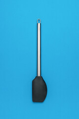 Black Silicone Spatula with Stainless Steel Handle on Blue Background - Modern Kitchen Utensil