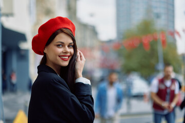 A beautiful smile woman with teeth walks in the city against the backdrop of office buildings,...