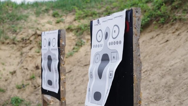 Paper targets with human silhouette on shooting range wooden stand, Czechia