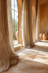 A room with a window and curtains, and a vase on the floor