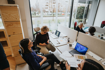 Professional business team engaging in collaborative work at modern office space.