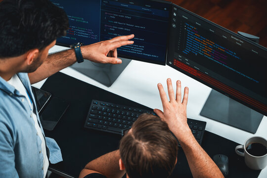 IT developers discussing online software development information on pc screen, creating program coding for latest version application on website. Concept of brainstorming firmware updated. Sellable.