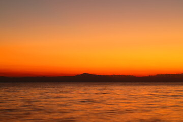 夕暮れの逗子海岸、オレンジ色に染まる空と海