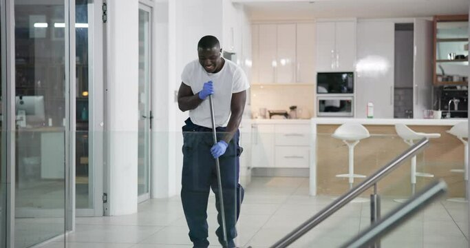 Man, cleaner and mopping with dancing in office at night for enjoyment, cleaning service fun and working with earphones. Janitor, African worker and movement at job for hygiene, housekeeping and maid