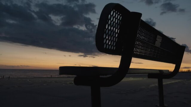 Handheld view of a bench during dusk.