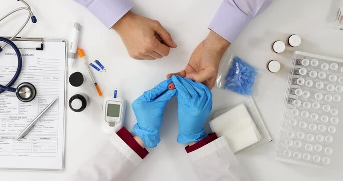 Doctor checks blood sugar level of patients top view