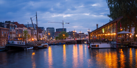 Historic buildings along the Canals of Leiden city in the Netherlands during twilight.