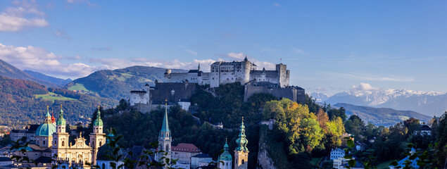 Panoramic view of Hohensalzburg Fortress against blue sky, a medieval fortress on a hilltop looking...
