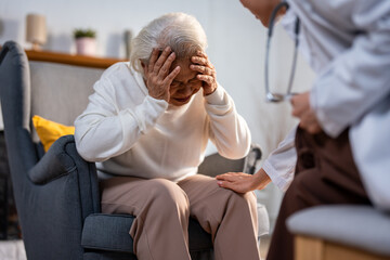 Asian caregiver nurse examine and listen to senior stress woman patient. 