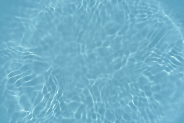 Defocus blurred transparent blue colored clear calm water surface texture with splashes reflection. Trendy abstract nature background. Water waves in sunlight with copy space. Blue watercolor shine.