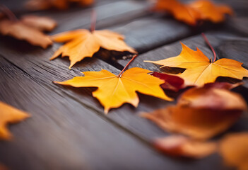 Close-up of vibrant orange and red autumn leaves scattered on a wooden surface, showcasing the beauty of fall foliage.