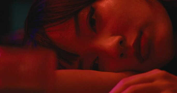 sad depressed young asiatic woman playing alone with a glass of alcohol cocktail white gaze empty and lost . mental health broken heart concept