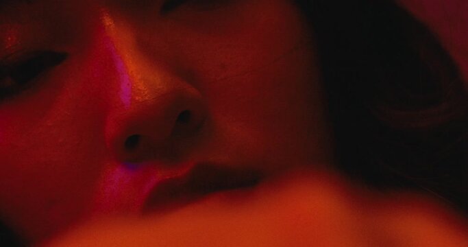 close up of a woman asiatic female model playing alone in a bar cafe club with a glass of whiskey cocktail , sorrow depression alcoholism concept