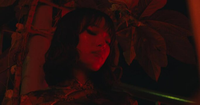 cinematic red light with asiatic woman female model girl portrait low angle