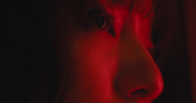 eyes close up of asiatic young sexy woman with dramatic red light