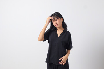 Portrait of overwhelmed Asian woman in casual shirt touching her head, having headache, and feeling stressed. Businesswoman concept. Isolated image on white background