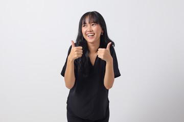 Portrait of attractive Asian woman in casual shirt making thumb up hand gesture, saying good job....