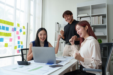 A team of young entrepreneurs and Asian startups Happy and grateful for success, encouraging each other for strength, positive concept, fighting with online work, successful marketing plan concept.