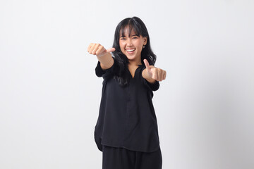Portrait of attractive Asian woman in casual shirt making thumb up hand gesture, saying good job....