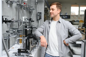Man chooses a products in a sanitary ware store