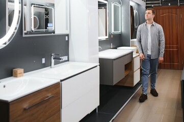 Middle age man choosing bathroom sink and utensils for his home