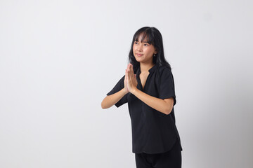 Portrait of attractive Asian woman in casual shirt showing apologize and welcome hand gesture....