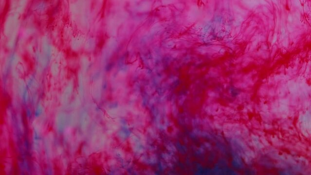Paint water. Biology ink. Defocused red blue color dripping blood liquid spilling capillaries anatomy fluid motion in wet texture abstract art background.