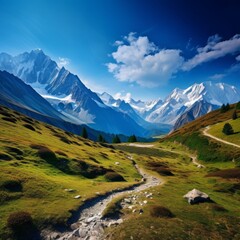 Fototapeta premium Tranquil mountain landscape with hiking trails leading to snow-capped peaks on a clear day