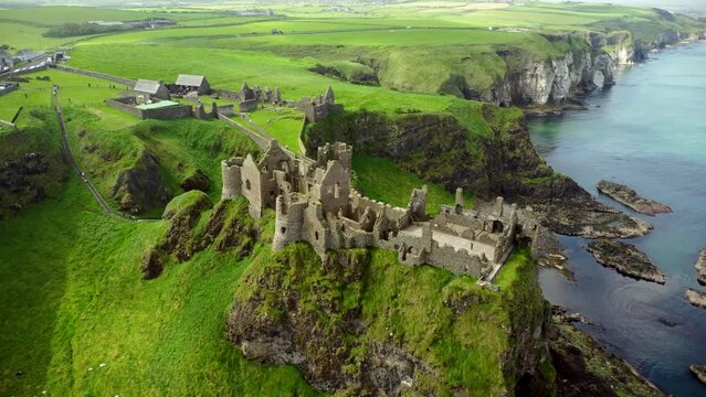 Aerial shot of Dunluce Castle, in Bushmills on the North County Antrim coast in Northern Ireland.

Ultra-wide of the castle ruins from overhead.

Produced in 4K, 30fps and in Rec709 color.
