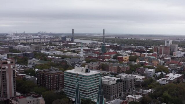 Wide reverse aerial pullback shot of the gothic spires atop the Cathedral Basilica of Saint John the Baptist in Savannah, Georgia. 4K