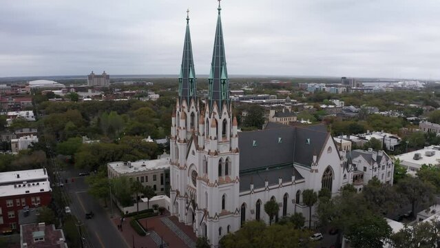 Aerial wide panning shot of the historic Cathedral Basilica of Saint John the Baptist in Savannah, Georgia. 4K