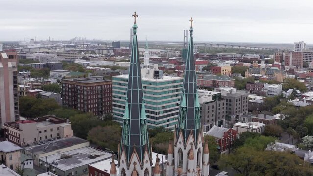 Aerial close-up rising shot of the gothic spires atop the Cathedral Basilica of Saint John the Baptist in Savannah, Georgia. 4K
