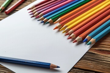 Obraz premium Colorful pencils on white paper, art concept, creative drawing workspace with copy space