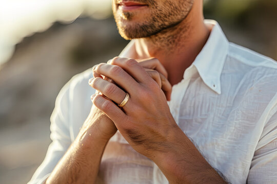 Man wearing engagement ring, signifying intentions to propose marriage