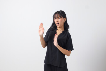 Portrait of attractive Asian woman forming a hand gesture to avoid something. Advertising concept....