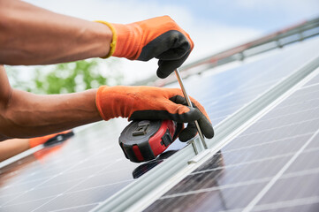 Cropped image of worker installing solar panel. Renewable and ecological energy. Idea of...