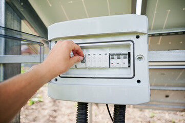 Pov worker turning on new solar panel. PV battery starts working. Another side of photovoltaic...