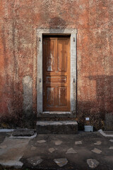 old wooden door in a red wall