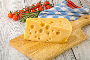 Maasdam cheese piece over board