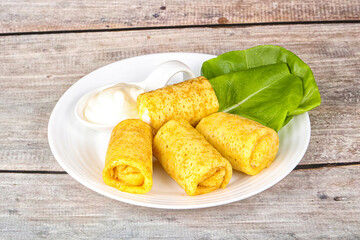 Stuffed pancakes with cream sauce