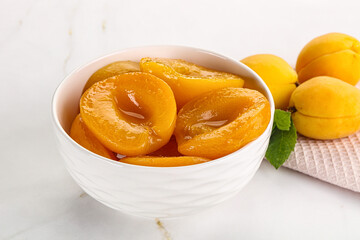 Few canned aprocots in the bowl