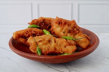 Tahu isi goreng is Indonesian fried tofu filled with vegetables and usually served with green chili