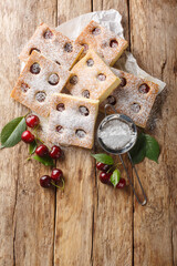 Bublanina pie fresh, juicy summer cherry enveloped in a soft sponge cake closeup on the parchment...